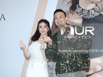 Dolly, a member of the girl group G.O.F., and Taiwanese singer Jason attend the opening ceremony of the dress brand in Taipei, Taiwan, on De...