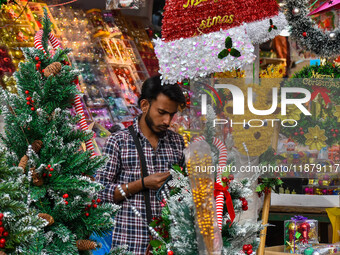 A shop sells decoration items for Christmas at a market ahead of Christmas in Kolkata, India, on December 18, 2024. (