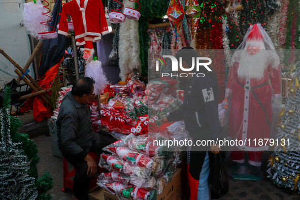 A shop sells decoration items for Christmas at a market ahead of Christmas in Kolkata, India, on December 18, 2024. 