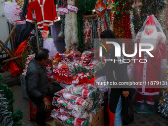 A shop sells decoration items for Christmas at a market ahead of Christmas in Kolkata, India, on December 18, 2024. (