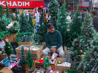 A shop sells Christmas trees at a market ahead of Christmas in Kolkata, India, on December 18, 2024. (