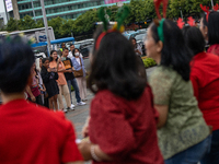 People take photos during the Christmas Carol to celebrate the upcoming Christmas in Jakarta, Indonesia, on December 18, 2024. This world's...