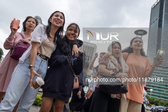 People sing together during the Christmas Carol to celebrate the upcoming Christmas in Jakarta, Indonesia, on December 18, 2024. This countr...