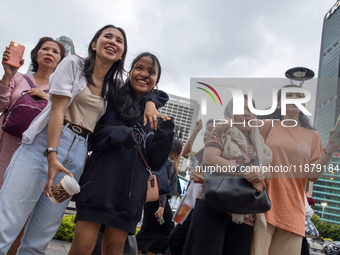 People sing together during the Christmas Carol to celebrate the upcoming Christmas in Jakarta, Indonesia, on December 18, 2024. This countr...