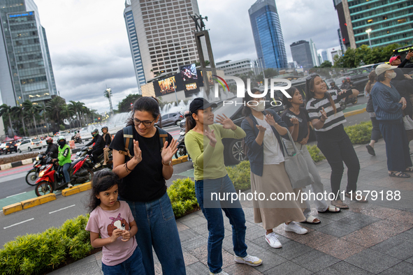 People dance during the Christmas Carol to celebrate the upcoming Christmas in Jakarta, Indonesia, on December 18, 2024. This world's larges...