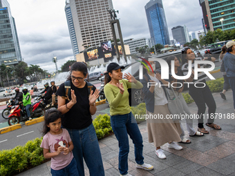 People dance during the Christmas Carol to celebrate the upcoming Christmas in Jakarta, Indonesia, on December 18, 2024. This world's larges...