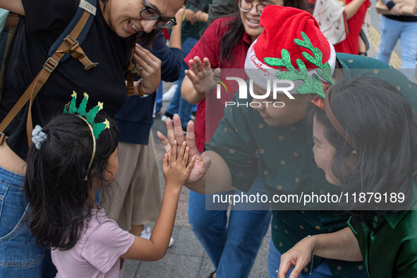 People sing together during the Christmas Carol to celebrate the upcoming Christmas in Jakarta, Indonesia, on December 18, 2024. This countr...