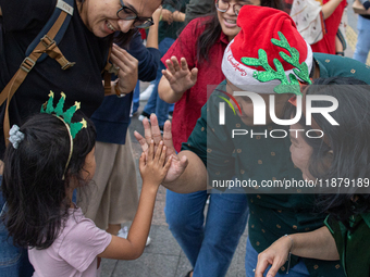 People sing together during the Christmas Carol to celebrate the upcoming Christmas in Jakarta, Indonesia, on December 18, 2024. This countr...