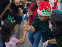 People sing together during the Christmas Carol to celebrate the upcoming Christmas in Jakarta, Indonesia, on December 18, 2024. This countr...