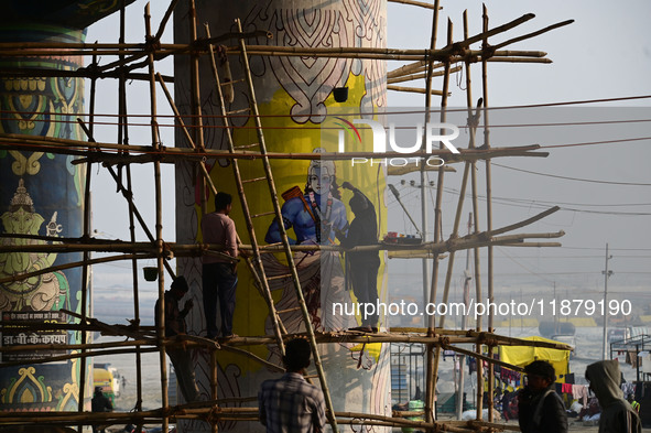 An artist creates a mural painting of the Hindu God Shri Ram on a pillar of the Shastri bridge over the river Ganges as part of the ongoing...