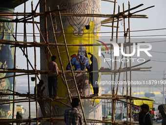 An artist creates a mural painting of the Hindu God Shri Ram on a pillar of the Shastri bridge over the river Ganges as part of the ongoing...