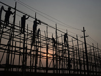 Labourers prepare a religious pandal or tent ahead of the upcoming Maha Kumbh Mela festival 2025 in Prayagraj, India, on December 18, 2024....