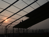 Labourers prepare a religious pandal or tent ahead of the upcoming Maha Kumbh Mela festival 2025 in Prayagraj, India, on December 18, 2024....