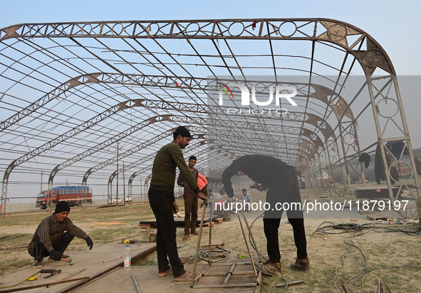 Labourers prepare a religious pandal or tent ahead of the upcoming Maha Kumbh Mela festival 2025 in Prayagraj, India, on December 18, 2024. 