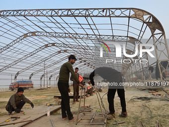 Labourers prepare a religious pandal or tent ahead of the upcoming Maha Kumbh Mela festival 2025 in Prayagraj, India, on December 18, 2024....