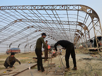 Labourers prepare a religious pandal or tent ahead of the upcoming Maha Kumbh Mela festival 2025 in Prayagraj, India, on December 18, 2024....