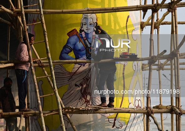 An artist creates a mural painting of the Hindu God Shri Ram on a pillar of the Shastri bridge over the river Ganges as part of the ongoing...