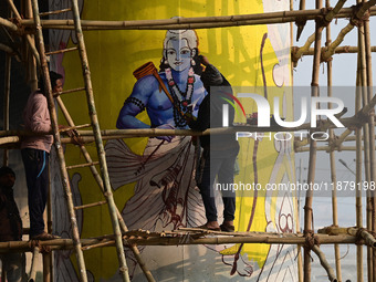 An artist creates a mural painting of the Hindu God Shri Ram on a pillar of the Shastri bridge over the river Ganges as part of the ongoing...