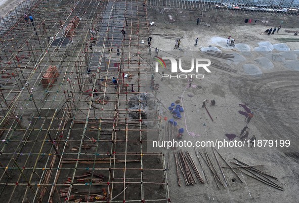 Labourers prepare a religious pandal or tent ahead of the upcoming Maha Kumbh Mela festival 2025 in Prayagraj, India, on December 18, 2024. 