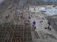 Labourers prepare a religious pandal or tent ahead of the upcoming Maha Kumbh Mela festival 2025 in Prayagraj, India, on December 18, 2024....