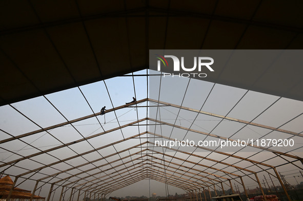 Labourers prepare a religious pandal or tent ahead of the upcoming Maha Kumbh Mela festival 2025 in Prayagraj, India, on December 18, 2024. 