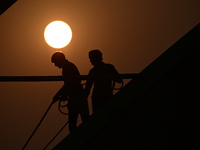 Labourers prepare a religious pandal or tent ahead of the upcoming Maha Kumbh Mela festival 2025 in Prayagraj, India, on December 18, 2024....