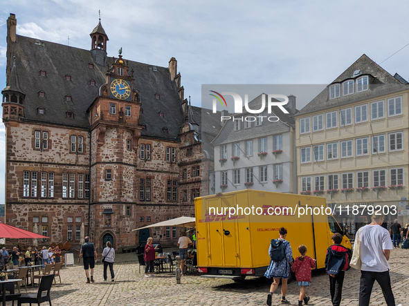 DHL delivers a parcel in Marburg, Germany, on August 14, 2023. 