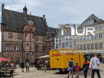 DHL delivers a parcel in Marburg, Germany, on August 14, 2023. (