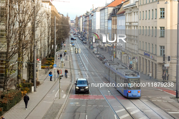 A tram travels along Bayerstrasse in Munich, Bavaria, Germany, on December 17, 2024. Pedestrians, cyclists, and vehicles share the busy urba...