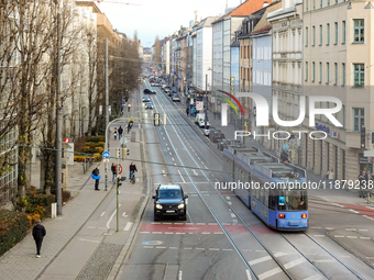 A tram travels along Bayerstrasse in Munich, Bavaria, Germany, on December 17, 2024. Pedestrians, cyclists, and vehicles share the busy urba...