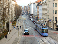 A tram travels along Bayerstrasse in Munich, Bavaria, Germany, on December 17, 2024. Pedestrians, cyclists, and vehicles share the busy urba...