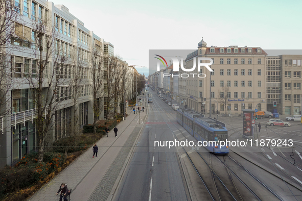 A tram travels along Bayerstrasse in Munich, Bavaria, Germany, on December 17, 2024. Pedestrians, cyclists, and vehicles share the busy urba...