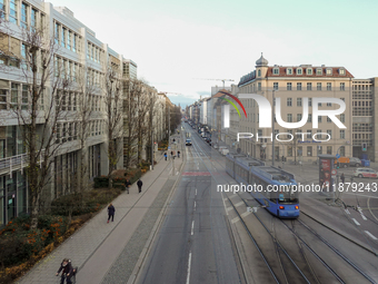 A tram travels along Bayerstrasse in Munich, Bavaria, Germany, on December 17, 2024. Pedestrians, cyclists, and vehicles share the busy urba...