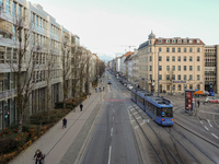 A tram travels along Bayerstrasse in Munich, Bavaria, Germany, on December 17, 2024. Pedestrians, cyclists, and vehicles share the busy urba...