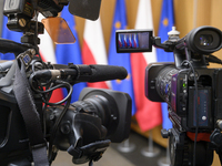 Video cameras are set against Poland's and EU flags before Polish Prime Minister Donald Tusk's press conference in Warsaw, Poland, on Decemb...