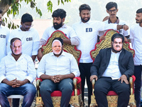 Indian National Congress (INC) workers wear masks of Indian industrialist and billionaire Gautam Adani (R), India's Prime Minister Narendra...