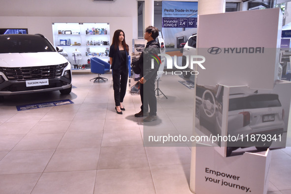 Hyundai cars of various types (hybrid, electric, and gasoline) are displayed at a dealership in Malang, East Java, Indonesia, on December 18...