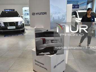 Hyundai cars of various types (hybrid, electric, and gasoline) are displayed at a dealership in Malang, East Java, Indonesia, on December 18...