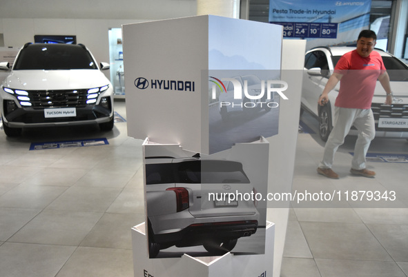 Hyundai cars of various types (hybrid, electric, and gasoline) are displayed at a dealership in Malang, East Java, Indonesia, on December 18...