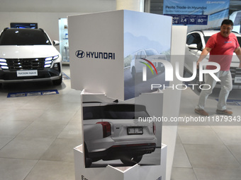 Hyundai cars of various types (hybrid, electric, and gasoline) are displayed at a dealership in Malang, East Java, Indonesia, on December 18...