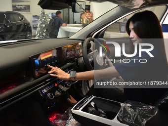 A customer tries out the luxurious interior of an electric Hyundai on display at a dealership in Malang, East Java, Indonesia, on December 1...