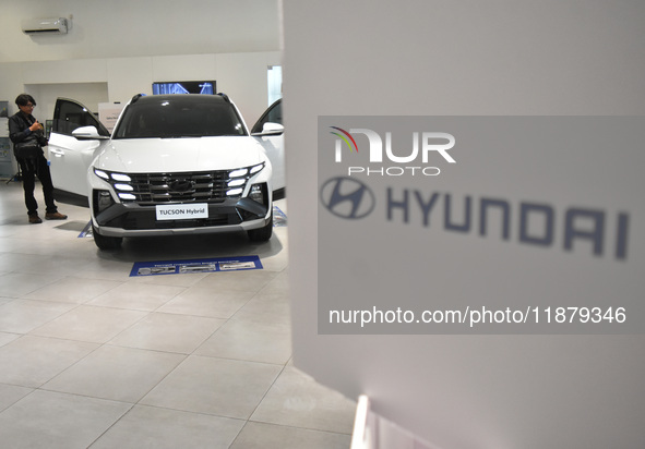 Hyundai cars of various types (hybrid, electric, and gasoline) are displayed at a dealership in Malang, East Java, Indonesia, on December 18...