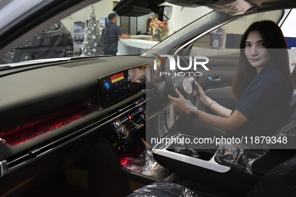 A customer tries out the luxurious interior of an electric Hyundai on display at a dealership in Malang, East Java, Indonesia, on December 1...