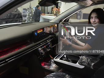 A customer tries out the luxurious interior of an electric Hyundai on display at a dealership in Malang, East Java, Indonesia, on December 1...