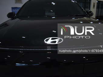 A Hyundai logo on a type of electric vehicle is displayed at a dealership in Malang, East Java, Indonesia, on December 18, 2024. Hyundai sal...