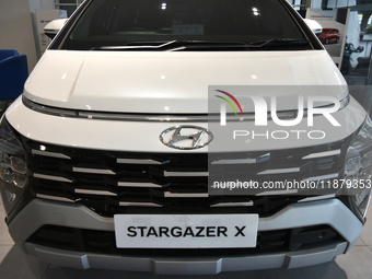 Hyundai cars of various types (hybrid, electric, and gasoline) are displayed at a dealership in Malang, East Java, Indonesia, on December 18...