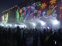 People enjoy the artificial snow during the opening of the 2024 Christmas Festival at the Zocalo in Mexico City, Mexico, on December 18, 202...