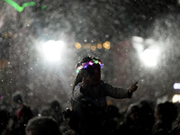 People enjoy the artificial snow during the opening of the 2024 Christmas Festival at the Zocalo in Mexico City, Mexico, on December 18, 202...