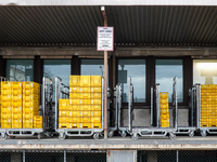 A Deutsche Post loading area in Munich, Germany, on December 18, 2024, contains yellow postal containers and trolleys positioned in the load...