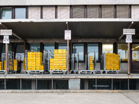 A Deutsche Post loading area in Munich, Germany, on December 18, 2024, contains yellow postal containers and trolleys positioned in the load...